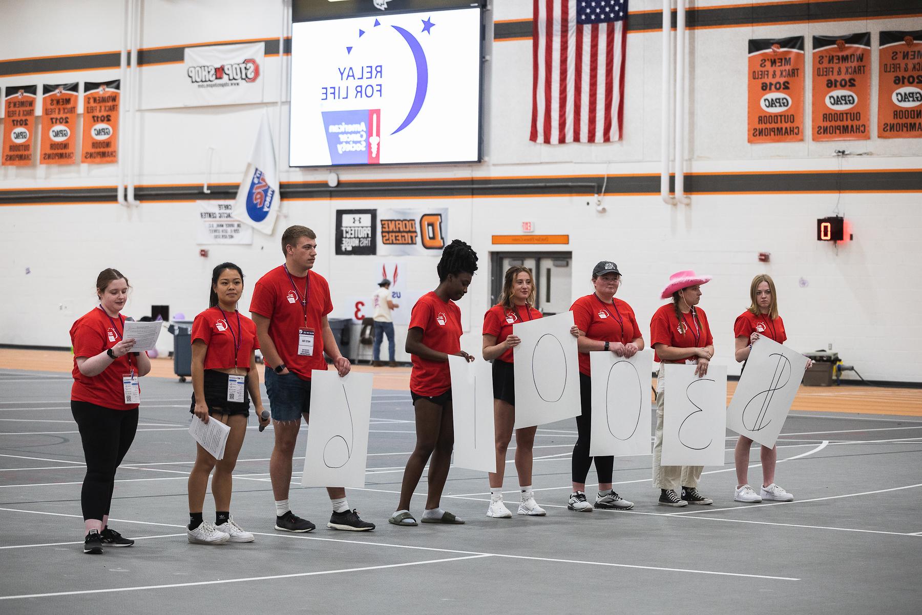 doane students posing with posters that say $30,016